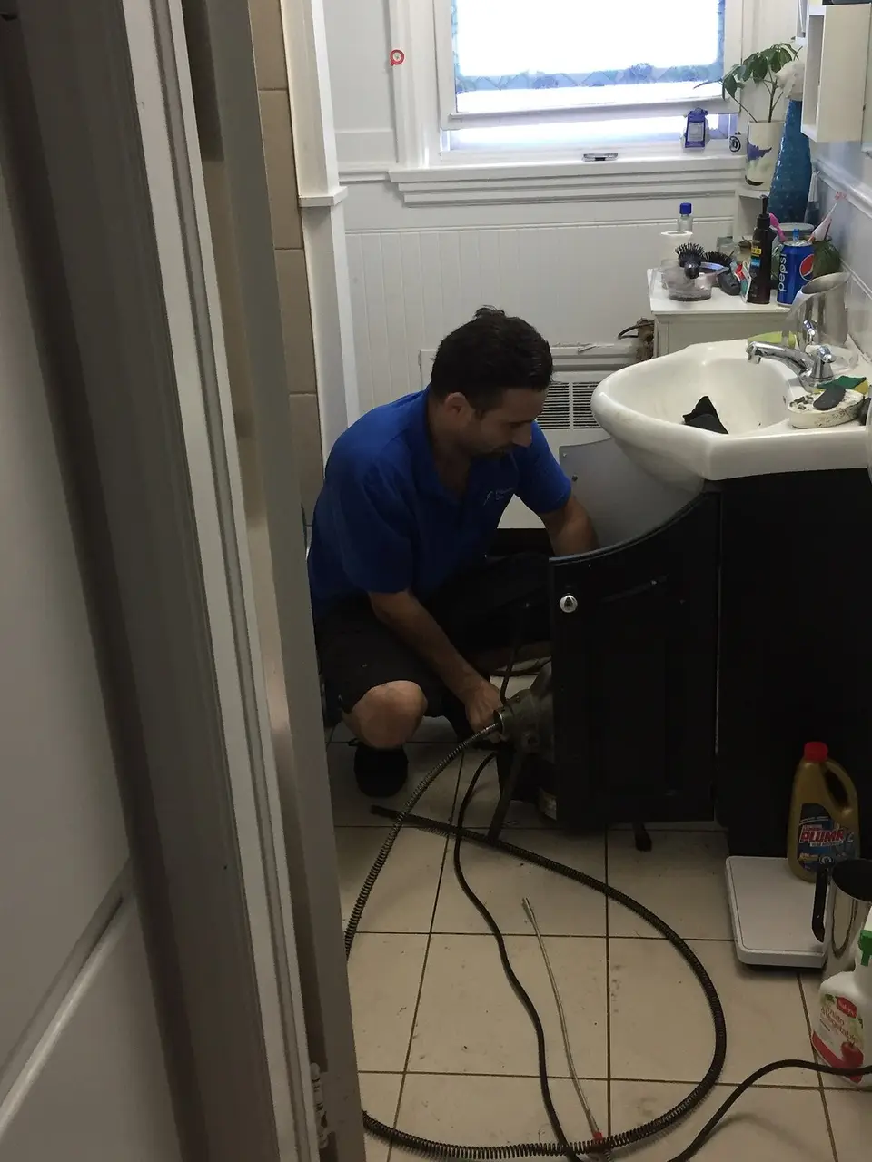 Licensed plumber working on a residential repair